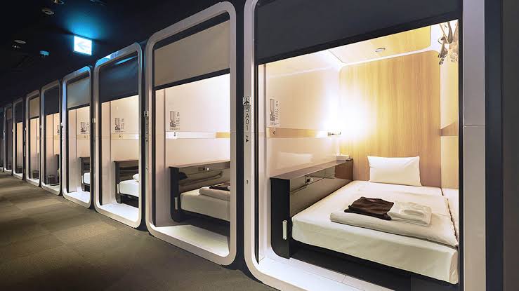 A row of fitted sleeping units along a shared corridor